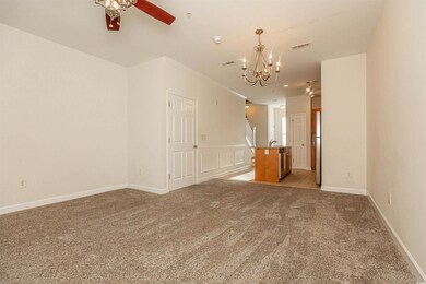 Empty room with light carpet, ornamental molding, 
