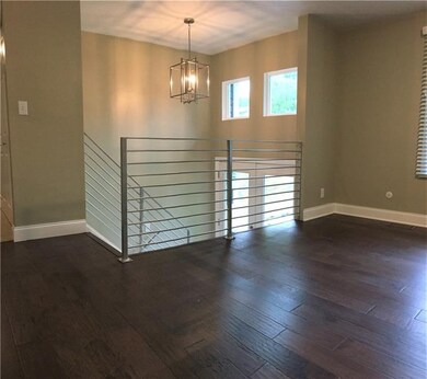 Wow!  What an entrance!  Beautiful open floor plan greets you upon entering the double glass doors with trendy chandelier which mirrors the 2 square windows above letting in additional light!  The beautiful hickory wideplank scraped flooring here ext