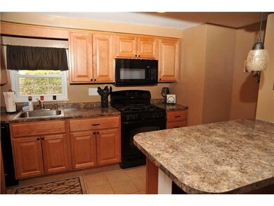 Kitchen. The updated kitchen has newer cabinets, c