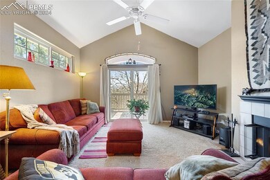 Carpeted living room featuring high vaulted ceilin