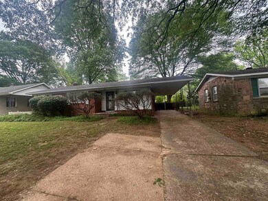 Single story home with an attached carport, concre
