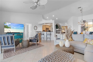 Tiled living room with ceiling fan with notable ch