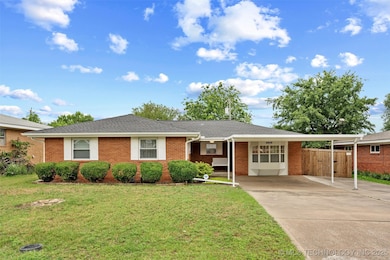 Ranch-style house with a carport, concrete drivewa