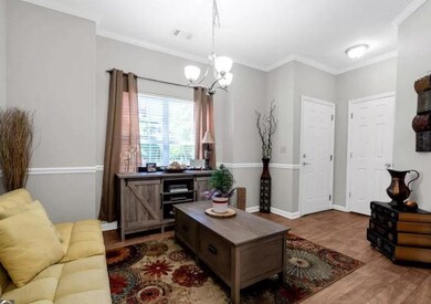 Living room featuring a chandelier, wood finished 