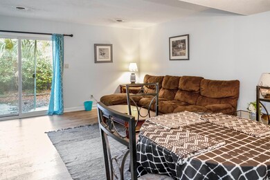 Living area with wood finished floors and baseboards