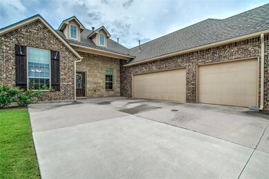 View of front of house with concrete driveway, a shingled roof, a garage, and brick siding