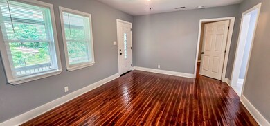 Enter into this lovely living room with dark hardw