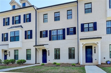 Townhome / multi-family property featuring brick s