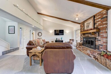 Living room with a fireplace, vaulted ceiling with
