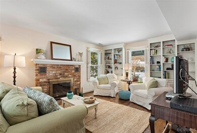 Cozy living room with built in bookcases, shutters