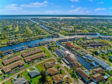 Birds eye view of property with a water view and a