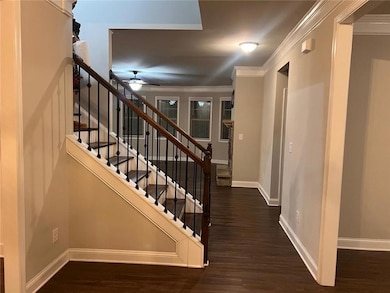 Stairway featuring ceiling fan, wood finished floo