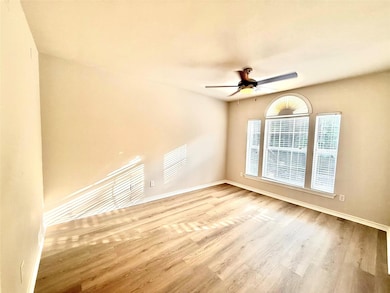 Spare room with wood finished floors and ceiling fan