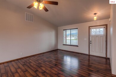 Large open space with vaulted ceilings, fan, and g