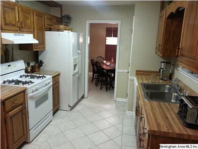 Kitchen with tile floors and pantry.