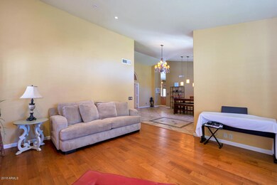 living room has wood floors and opens to