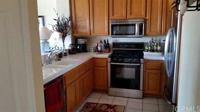Tiled kitchen opens to dining.