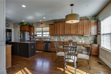 Expansive and sunny eat-in kitchen. Imagine having morning coffee and enjoying the view.