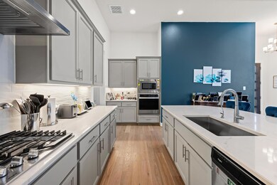 Kitchen with stainless steel appliances, ventilat