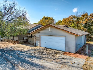Garage with concrete driveway and a gate