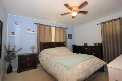 The large master bedroom has ample space for a kin