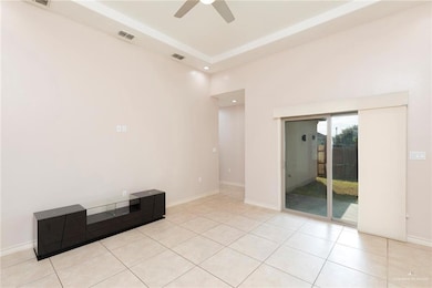 Unfurnished room with a raised ceiling, recessed lighting, light tile patterned flooring, and ceiling fan