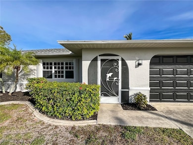 View of exterior entry with a garage, stucco sidin