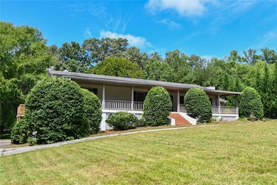 View of front of house featuring a front lawn and a porch