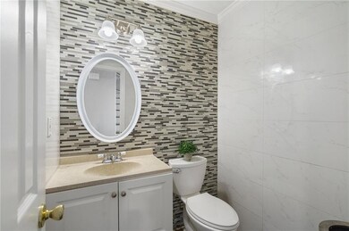 Bathroom featuring tasteful backsplash, tile walls