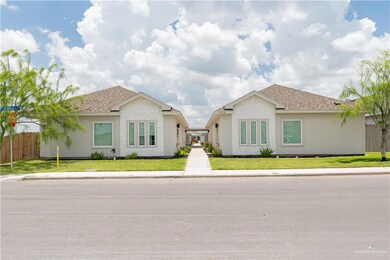 Ranch-style house featuring roof with shingles and stucco siding