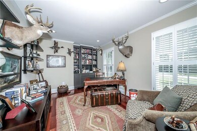 Office off foyer with built ins and plantation shu