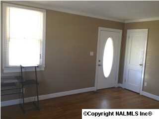 Original hardwood flooring graces the living room and bedrooms.