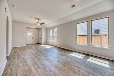 The dining area seamlessly integrates with the family room, where its large windows and recessed lighting create an inviting atmosphere for family meals or hosting events. Gleaming vinyl plank flooring adds a contemporary touch, providing easy maintenance and durability, perfect for everyday living and entertaining.