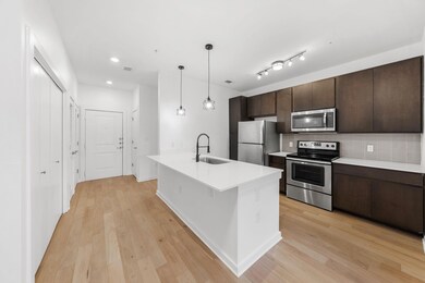 Kitchen featuring light wood finished floors, dar