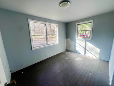 Empty room with hardwood / wood-style floors