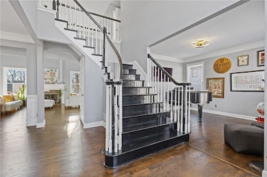 Stairway with a towering ceiling, wood-type floori