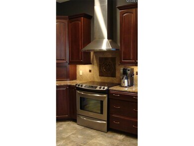 Tile backspash with inlaid work and metal accents
