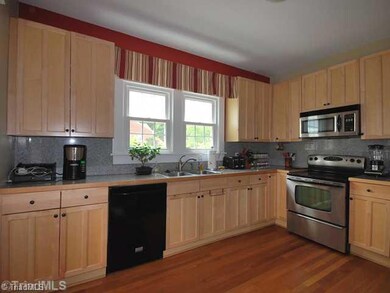 Kitchen. Granite tile counters and attractive cabinetry