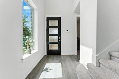 Foyer entrance featuring stairs and wood finished