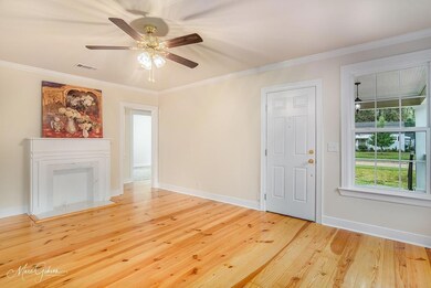 Unfurnished living room featuring hardwood / wood-