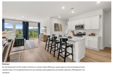 Kitchen with open floor plan, a breakfast bar, white cabinets, recessed lighting, and appliances with stainless steel finishes