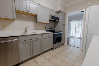 Kitchen featuring crown molding, sink, gray cabine