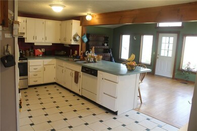 Kitchen with tile floor, peninsula opens to the fa