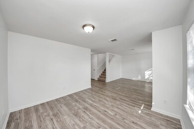 This is a view of the formal dining and formal living areas — notice how spacious and open the layout is!