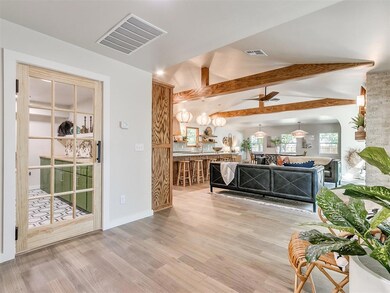 View into utility room, living room and kitchen