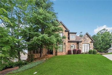 View of front of property featuring stone siding and a front yard