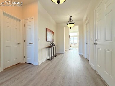 Hallway featuring light wood-style floors and baseboards