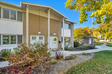View of front of house with a front yard and brick siding