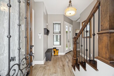 Entry foyer: chandelier, coat closet w/ rod and sh