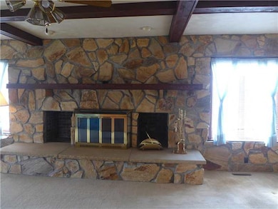 Family Room. The fireplace is flanked by two windo